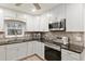 Modern kitchen with stainless steel appliances and granite countertops at 8723 Sw 93Rd Ln # C, Ocala, FL 34481
