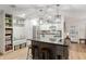 Bright kitchen with stainless appliances, an island with seating, and built in shelving with seat at 8723 Sw 93Rd Ln # C, Ocala, FL 34481