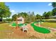 Enjoy Gathering fun at the miniature golf course with landscaped greens and a bench for relaxing at 8723 Sw 93Rd Ln # C, Ocala, FL 34481