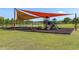 Outdoor playground with swings, slides, and shaded seating area provides a fun space for  at 8723 Sw 93Rd Ln # C, Ocala, FL 34481