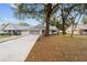 Ranch style home with a large driveway and mature trees at 8851 Sw 92Nd Pl # E, Ocala, FL 34481