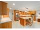 Bright kitchen boasts an island, stainless steel appliances, and wood cabinets at 8851 Sw 92Nd Pl # E, Ocala, FL 34481