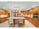 Large kitchen with island, stainless steel appliances, and wood cabinets at 8851 Sw 92Nd Pl # E, Ocala, FL 34481