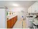 Laundry room with washer, dryer, cabinets, and countertop workspace at 8851 Sw 92Nd Pl # E, Ocala, FL 34481
