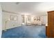 Living room with blue carpet, off-white couch, and wood cabinet at 8851 Sw 92Nd Pl # E, Ocala, FL 34481