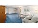 Living room with blue carpet, off-white couch and coffee table at 8851 Sw 92Nd Pl # E, Ocala, FL 34481