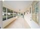 Spacious screened porch with tiled floor and ceiling fan at 8851 Sw 92Nd Pl # E, Ocala, FL 34481