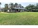 Single story home with green lawn at 1040 Se 9Th Ave, Ocala, FL 34471