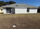 White house exterior with gray roof and sliding glass doors at 11120 Sw 71St Terrace Rd, Ocala, FL 34476