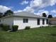 White house exterior with gray roof and landscaping at 11388 Sw 138Th Ln, Dunnellon, FL 34432