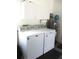 Bright laundry room with washer, dryer, and cabinets at 11388 Sw 138Th Ln, Dunnellon, FL 34432