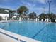 Community swimming pool with lounge chairs at 11388 Sw 138Th Ln, Dunnellon, FL 34432