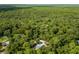 Aerial view of a home nestled in a lush, wooded area at 1143 Se 159Th Ct, Silver Springs, FL 34488