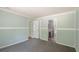 Spacious bedroom with gray carpet and access to bathroom at 1143 Se 159Th Ct, Silver Springs, FL 34488