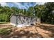 Rear view of gray mobile home with AC unit at 1143 Se 159Th Ct, Silver Springs, FL 34488