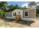 Gray and white mobile home with wooden steps and landscaping at 1143 Se 159Th Ct, Silver Springs, FL 34488