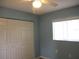 Bedroom with light wood floors, double door closet and ceiling fan at 11500 Sw 136Th Pl, Dunnellon, FL 34432