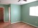 Bedroom with hardwood floors and access to closet and bathroom at 11500 Sw 136Th Pl, Dunnellon, FL 34432