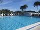 Community pool with surrounding lounge chairs and signage at 11500 Sw 136Th Pl, Dunnellon, FL 34432