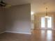 Bright dining room with light hardwood floors and a modern chandelier at 11500 Sw 136Th Pl, Dunnellon, FL 34432