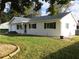 White single story home with dark shutters, attached garage, and landscaped lawn at 11500 Sw 136Th Pl, Dunnellon, FL 34432