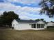 White house exterior with a screened porch at 11500 Sw 136Th Pl, Dunnellon, FL 34432