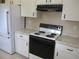 Kitchen with white cabinets, range, and granite countertops at 11500 Sw 136Th Pl, Dunnellon, FL 34432