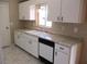 Kitchen with white cabinets, double sink, and granite countertops at 11500 Sw 136Th Pl, Dunnellon, FL 34432