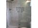 Large walk-in shower with marble tile and glass enclosure at 11500 Sw 136Th Pl, Dunnellon, FL 34432