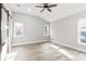 Bright bedroom with wood-look floors and barn door at 11759 Bostick St, Dunnellon, FL 34432