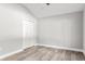 Simple bedroom with wood-look floors and white closet doors at 11759 Bostick St, Dunnellon, FL 34432