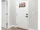 White interior door with a glass paneled top and black hardware at 11759 Bostick St, Dunnellon, FL 34432