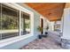 Inviting covered front porch with brick pavers and a detailed wood ceiling at 11759 Bostick St, Dunnellon, FL 34432