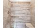 Walk-in shower with wood-look tile and built-in seat at 11759 Bostick St, Dunnellon, FL 34432