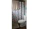 Bathroom with seashell shower curtain and white toilet at 137 Marion Oaks Ln, Ocala, FL 34473