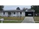 Gray house with solar panels, carport, and driveway at 137 Marion Oaks Ln, Ocala, FL 34473