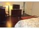 Spacious bedroom featuring hardwood floors, a decorative lamp, and a modern television at 13779 Sw 111Th Ave, Dunnellon, FL 34432