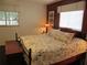 Spacious bedroom with large windows, a floral patterned bedspread, and a coordinating wood bench at 13779 Sw 111Th Ave, Dunnellon, FL 34432