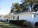 House exterior view, white siding, landscaping, and large tree at 13779 Sw 111Th Ave, Dunnellon, FL 34432