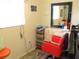 Small salon with red styling chair and mirror at 13779 Sw 111Th Ave, Dunnellon, FL 34432