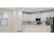 Modern kitchen with white cabinets, stainless steel appliances, and an island at 13824 Se 42 Ave, Summerfield, FL 34491