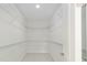 Large walk-in closet with ample shelving at 13824 Se 42 Ave, Summerfield, FL 34491