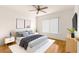 Main bedroom with ceiling fan and wood flooring at 13957 Se 86Th Cir, Summerfield, FL 34491