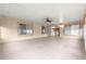 Large screened porch with tile flooring and a ceiling fan at 13957 Se 86Th Cir, Summerfield, FL 34491