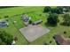 Aerial view of home with horse stables and horse training ring at 14130 Sw 8Th Ave, Ocala, FL 34473