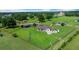 Expansive fenced property featuring a home with a metal roof, a barn, and lush green pastures at 14130 Sw 8Th Ave, Ocala, FL 34473