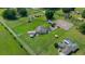 Aerial view of fenced in property, including home, horse areas, and sprawling property at 14130 Sw 8Th Ave, Ocala, FL 34473