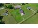 Aerial view of sprawling property, fenced yard, horse stables, home, and additional horse areas at 14130 Sw 8Th Ave, Ocala, FL 34473