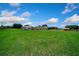 Expansive green lawn, horse trailer, storage shed, and back of home at 14130 Sw 8Th Ave, Ocala, FL 34473