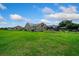 Beautiful, spacious backyard, complete with lush green grass, and a screened-in pool at 14130 Sw 8Th Ave, Ocala, FL 34473